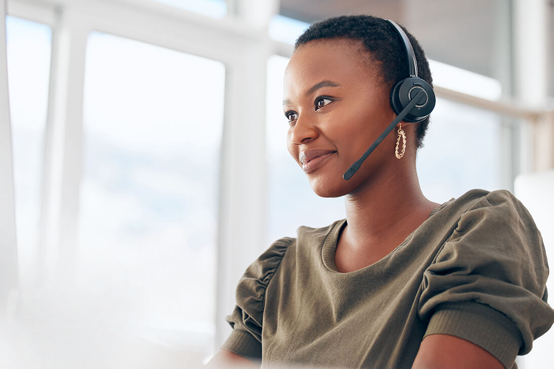 A smiling lady with a headset