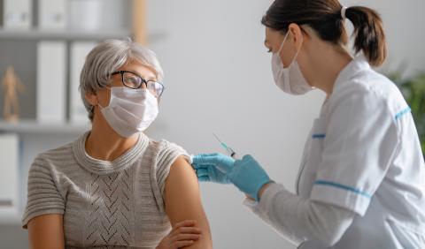 Woman receiving COVID vaccine