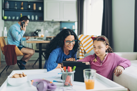 family on devices in the home